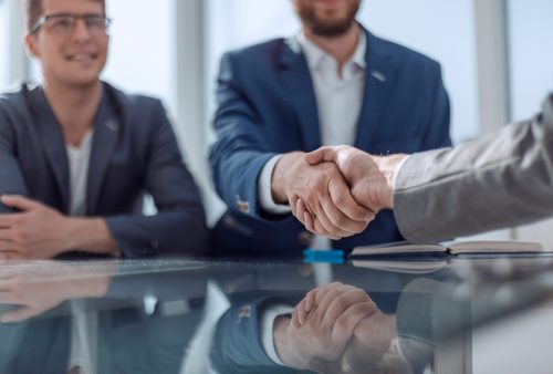 close up. business handshake over the office Desk