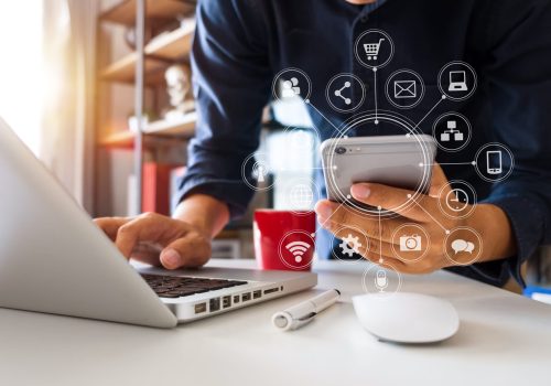 close up of hand using tablet ,laptop, and holding smartphone on